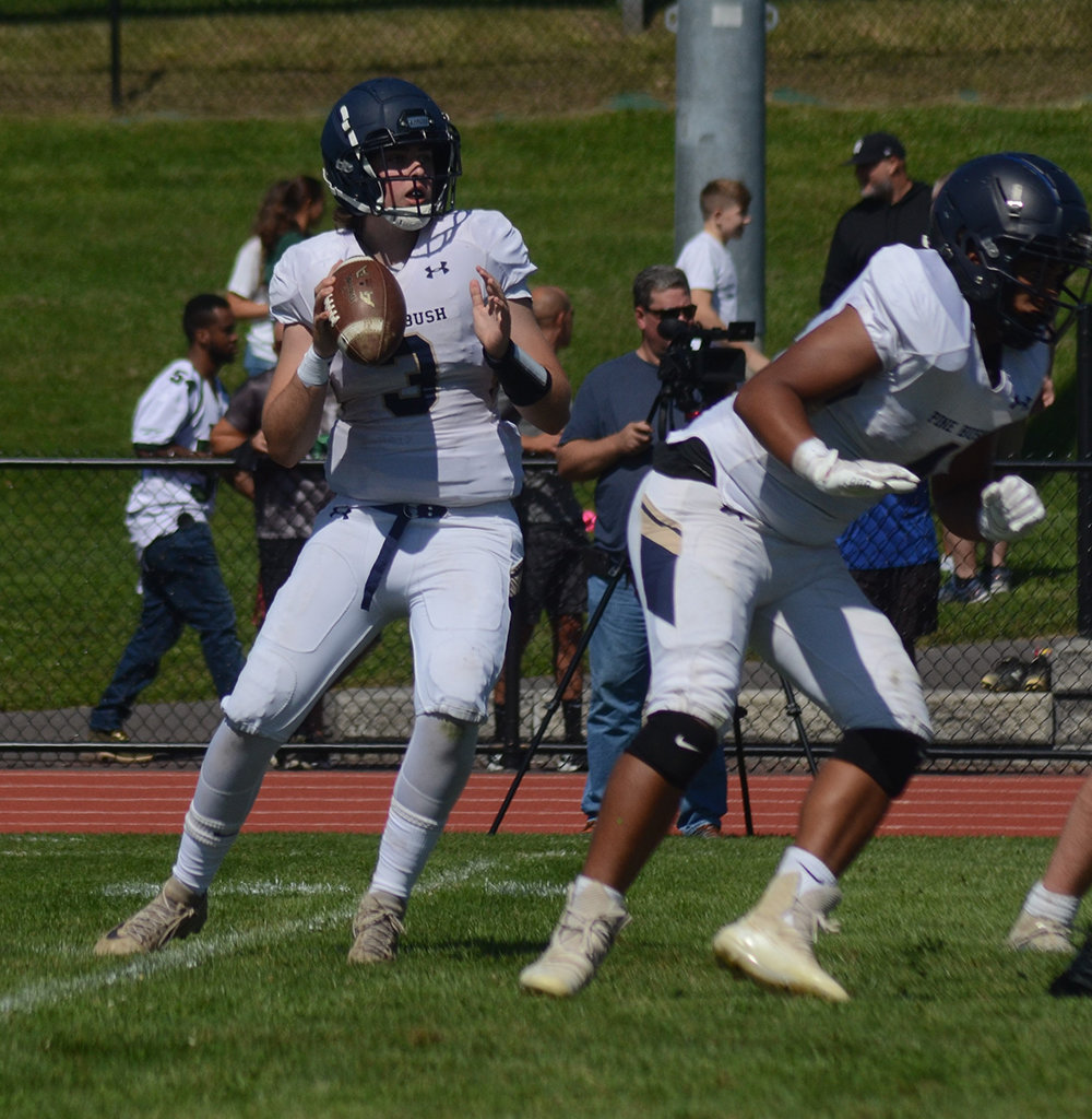 Pine Bush quarterback Danny DeGroodt drops back to pass as Dion Cauthen blocks during Saturday’s non-league football game at Minisink Valley High School.
